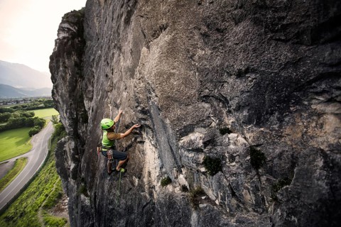 Climber lead climbing on a rock face