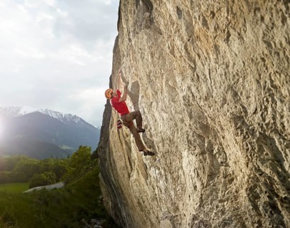 Climber lead climbing on a rock face