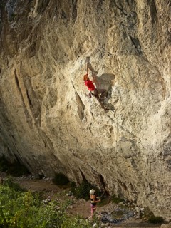 Climber lead climbing on a rock face