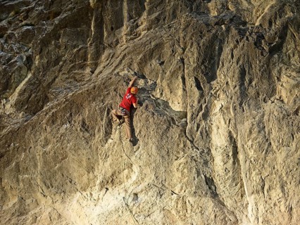 Climber lead climbing on a rock face