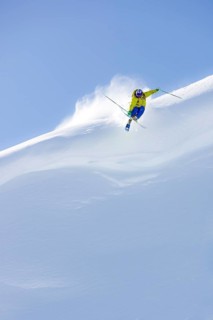 Freerider jumping off snow cornice