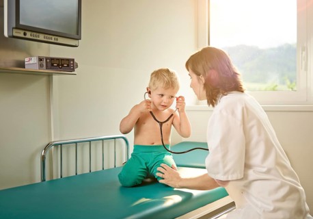 Pediatrician examining boy