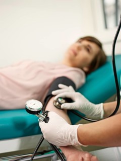 Nurse measuring patient's blood pressure