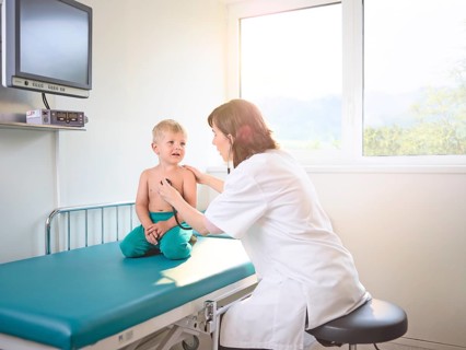 Pediatrician examining boy