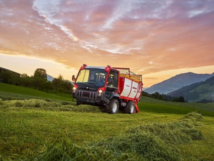 Unitrac transporter with forage trailer collecting the dried grass