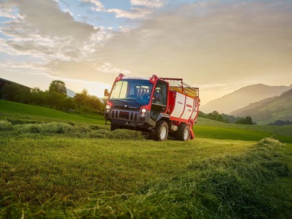 Unitrac transporter with forage trailer collecting the dried grass