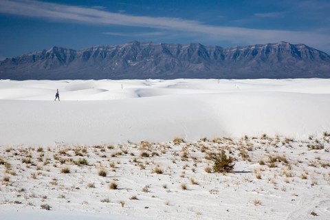 A woman hiking in White Sands National Monument