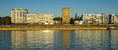 Houses with Bayenturm defence tower by the river Rhein