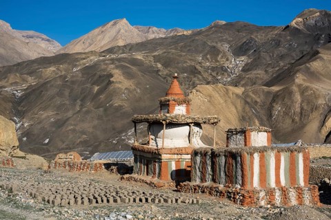 Buddhist stupas in front of mountain landscape