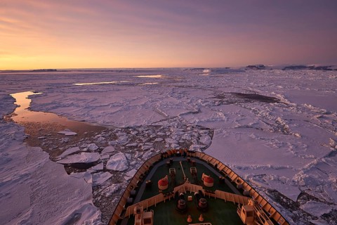 Bow of the icebreaker Kapitan Khlebnikov in the sea ice at afterglow