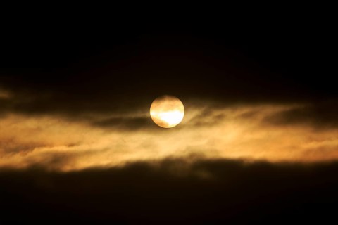 Sun between dark clouds