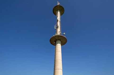 Transmission tower against blue sky