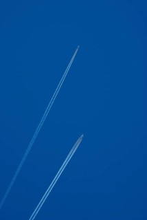 Contrails of two aircrafts in a blue sky