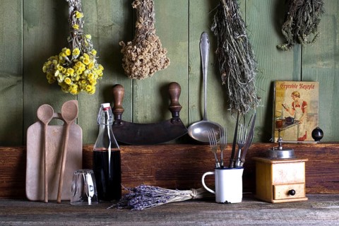 Rustic kitchen still life with kitchen utensils and dried herbs