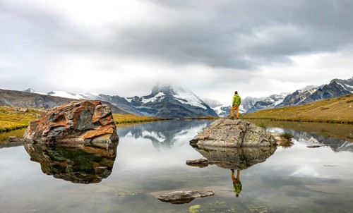 Hiker standing on rocks in the lake