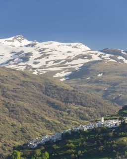 View over the town of Pampaneira towards the snow-capped Sierra Nevada Mountains