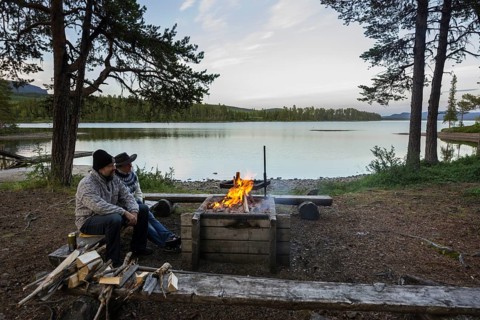 Couple sitting at a campfire