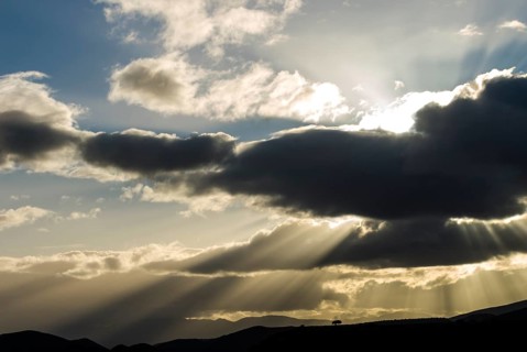 Sun rays breaking through the clouds in the evening light