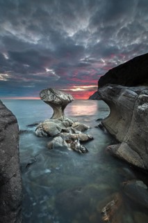 Kannestein or Kanne Stone with coastline at sunset