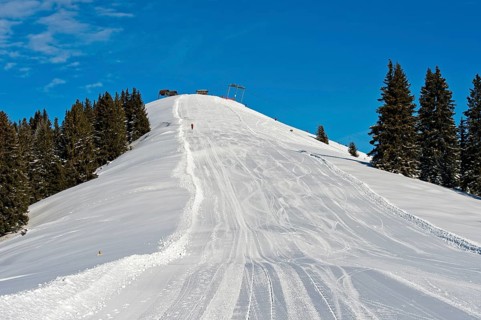 Empty ski slope under a blue sky
