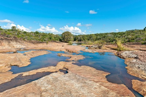 Tropical dry forest landscape with river and rocks