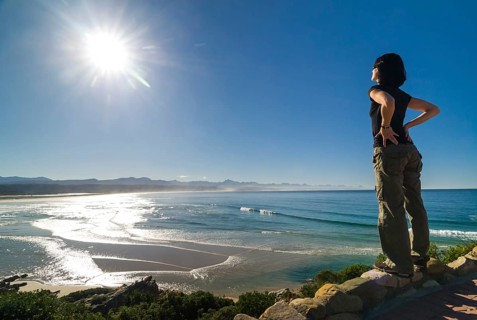 Young woman looking at a bay and the Indian Ocean