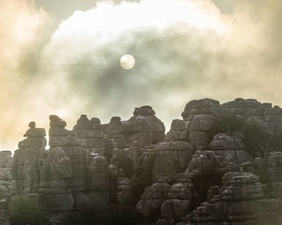 Bizarre limestone rock formations with the sun and fog