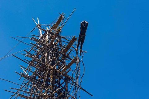 Man jumping from a bamboo tower
