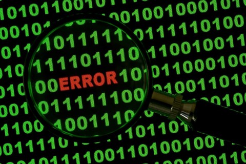 Binary code with the word 'Error' viewed through a magnifying glass