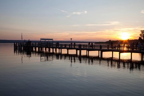 Jetty on Ammersee Lake or Lake Ammer in the evening light