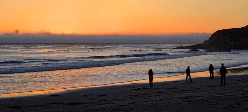 People at sunset at the Pacific beach of Cambria