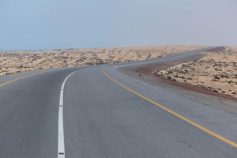 Omani highway through the sand desert