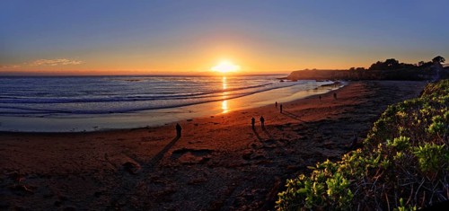 People at sunset at the Pacific beach of Cambria