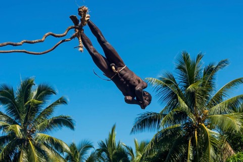 Man jumping from a bamboo tower