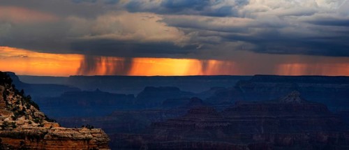 View of the Grand Canyon at sunset with storm clouds
