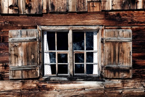 Old wooden window of a mountain hut