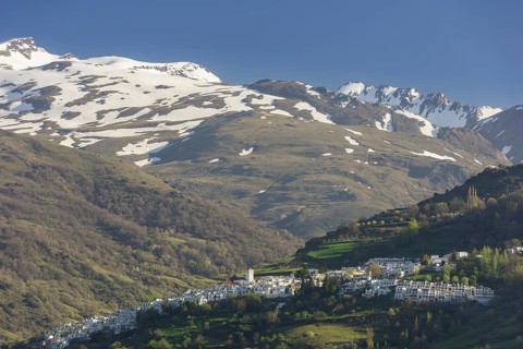 View over the town of Pampaneira towards the snow-capped Sierra Nevada Mountains