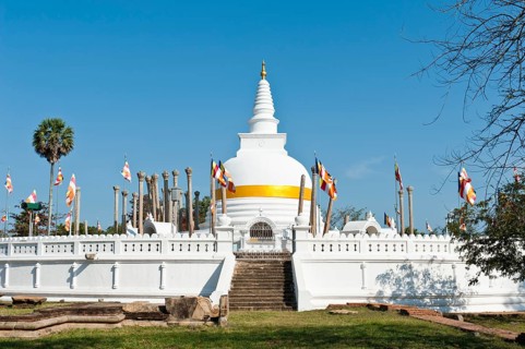 Old white stupa with orange ribbon