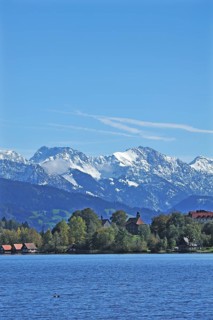 Snow-covered Oberstdorf Mountains behind Buhl am Alpsee with Alpsee lake