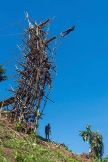 Man jumping from a bamboo tower