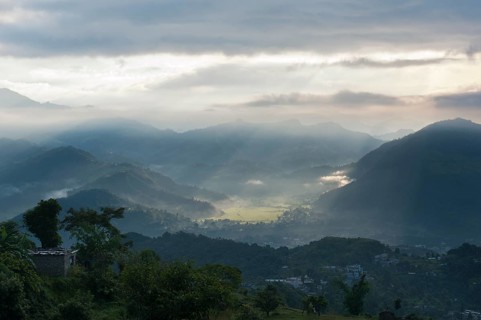 First sun rays of the morning filtering through the mist