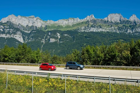 Vehicles on the A3 motorway in front of the Churfirsten range near Lake Walen