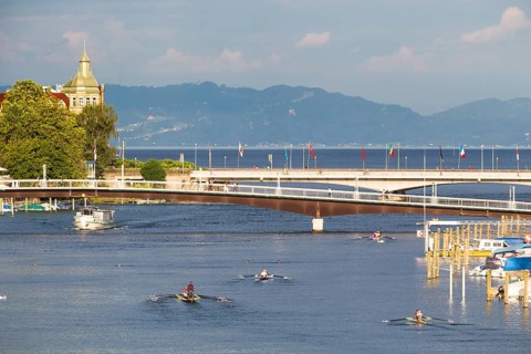 Passenger ship and rowing boats on the Rhine River