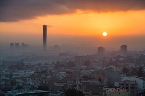 Sunrise over city with minaret of Great Mosque of Algiers