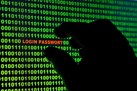 Hand reaching for the words 'Login Passwort' in a binary code