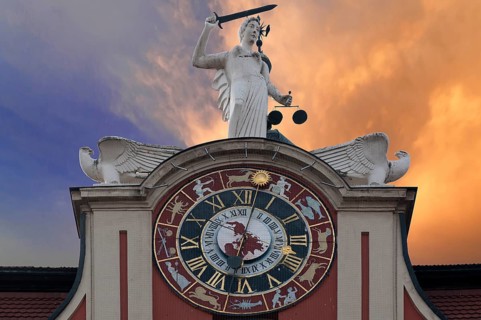Astronomical clock with a statue of Justice on the Baroque town hall of Bad Windsheim