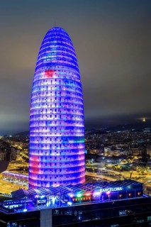Blue illuminated Agbar Tower and city at Night