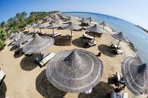 Sun umbrellas on a beach of Marsa Alam