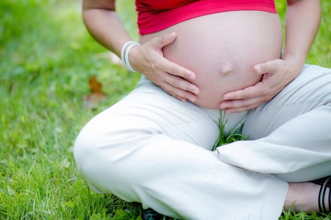 Pregnant woman touching her baby belly