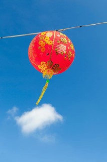 Red Chinese New Year lantern against blue sky